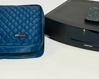 Bose Wave CD player with alarm clock. Incudes Remote. Shown here with a CD binder. The binder has 84 CDs and is sold separatey.