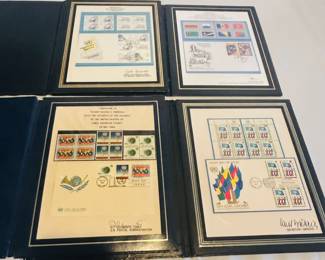 The inside of four portfolios, each with a different United Nations first day cover and stamps. Dates are 1964, 1975, 1986 and 1999.