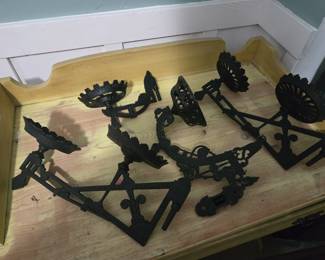 Cast iron hanging oil lamp holders.