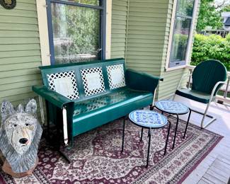 Vintage porch glider, rugs, tile top tables, carved wolf, metal bouncer chair