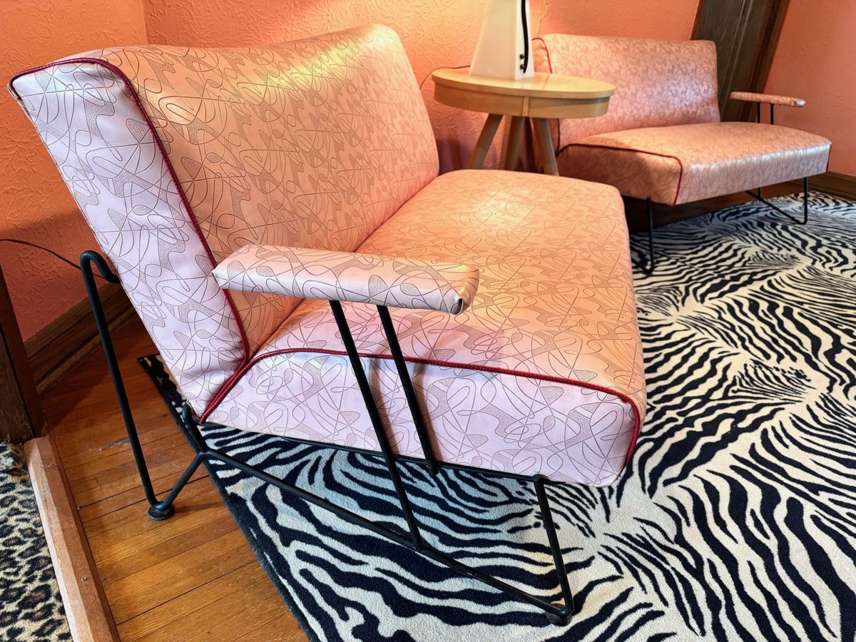 Amazing 1950’s Dan Johnson for Pacific iron two-piece sofa set in pink boomerang vinyl upholstery