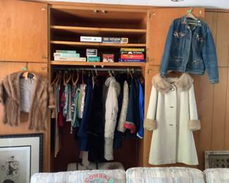 Vintage clothing….brocade coat with mink trim, blue Jean jacket filled with pins, mink stole and other coats and tablecloths