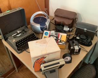 Two vintage typewriters, and many older cameras….some with original box