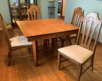 Antique oak 42” square table and 29” high. Has 4 leaves at 10” each and 4 chairs. Chairs are 20” w x 18” d x 42” h