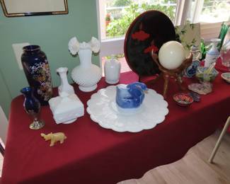 Tables of Milk Glass, Asian vase, plate, ostrich egg and stand, blus glass.