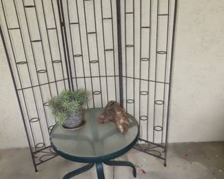 Iron screen, end table and plant.