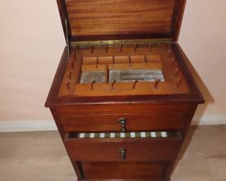 Antique sewing notions storage cabinet.