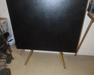 Two vintage black and gold folding tables.