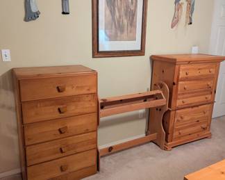 View of two dressers and quilt rack.