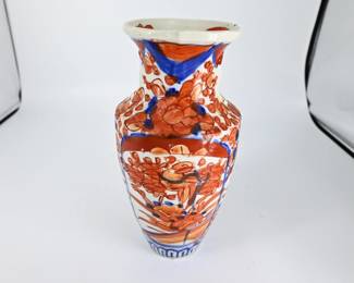 Colorful Imari-style porcelain vase featuring bold floral and bird motifs in traditional iron red and cobalt blue. Square-lobed rim and painterly aesthetic suggest mid-20th century decorative origin. Likely Japanese or Chinese export. Estimated date: 1950s–1980s.