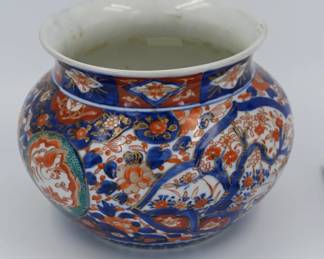 A fine example of high-quality Imari porcelain craftsmanship with early Kutani influence. Features richly hand-painted decoration in cobalt blue, iron red, gold, and green, with floral and cartouche motifs in a dense, kinrande-style composition. Estimated date: 1850–1880