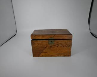 A refined Japanese tea chest featuring warm hardwood veneer with decorative inlay and twin black lacquer interior lids, each adorned with delicate maki-e floral motifs and original brass pulls. Estimated date: 1890-1910