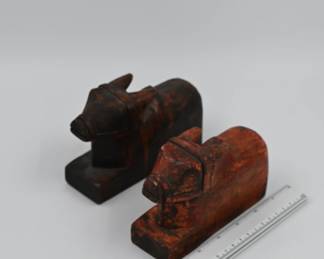 Pair of carved wooden horses, featuring geometric forms and remnants of original red pigment. Possibly temple or ceremonial cart elements. Estimated date: late 19th to early 20th century.