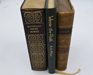 Antique books including Winnie-the-Pood, Fables by Fontaine, and a collection of Maupassant short stores.