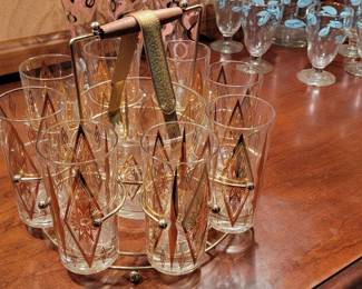 Gold trimmed glasses (8) with ice bucket in rack