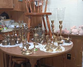 Round Maple Dining Table and 4 Chairs. Lots of Brass candlesticks in various shapes and forms.