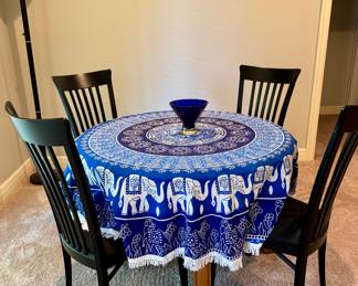 Tablecloth from Israel, blue glass bowl, 4 black dining chairs and wood table with two leaves