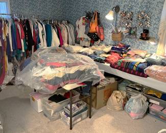 This table full of clothing, bedding, towels, etc.