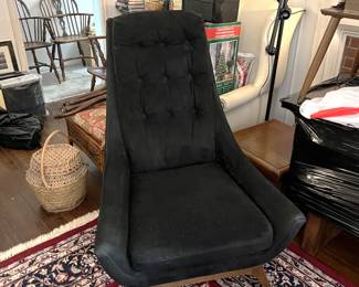 This is an interesting black easy chair. The black covering makes showing the details a bit tricky, but it is in good shape.