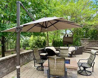 Cantilever Umbrella with Set of 4 High-Back Sling Swivel Rocker Chairs by Hampton Bay.