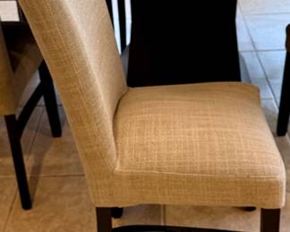Oval Dining Table with 8 Slipper Chairs in Light Tan. Perfect for an Eat-In Kitchen or Dining Room