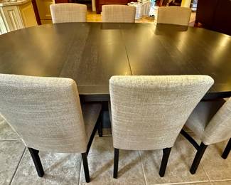 Oval Dining Table with 8 Slipper Chairs in Light Tan. Perfect for an Eat-In Kitchen or Dining Room
