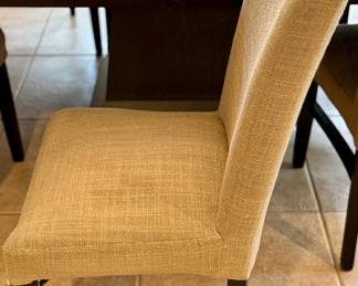 Oval Dining Table with 8 Slipper Chairs in Light Tan. Perfect for an Eat-In Kitchen or Dining Room