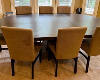 Oval Dining Table with 8 Slipper Chairs in Light Tan. Perfect for an Eat-In Kitchen or Dining Room