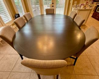 Oval Dining Table with 8 Slipper Chairs in Light Tan. Perfect for an Eat-In Kitchen or Dining Room