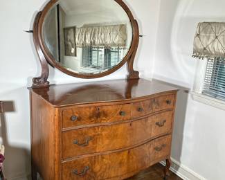Serpentine Front Dresser With Mirror | Vintage burlwood four-drawer dresser with serpentine front, hardware and attached oval-shaped mirror with ornate details. Mirror: h. 36 - h. 69.75 x w. 46 x d. 24 in