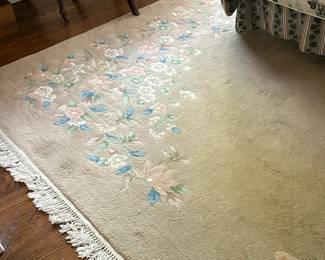 Floral Patterned Area Rug | Area rug (approximately 8' x 11') with blue and pink floral pattern atop a beige/tan-colored base with white tasseled trim. - w. 101 x l. 143 in