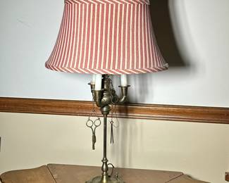 Faux Candelabra Brass Table Lamp |
Brass 3-light candelabra (electrified) table lamp with attached tools and red-and-white pin-stripe lampshade. - h. 27.5 x dia. 6 in