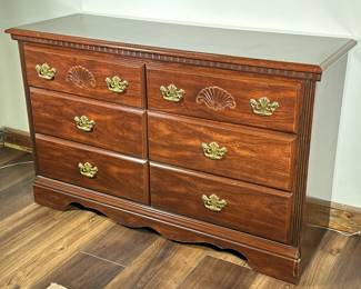 Six-Drawer Wooden Dresser | Six-drawer wooden dresser with gold hardware and carved details. - h. 31 x w. 50 x d. 17 in