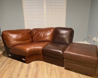Soft leather curved loveseat with ottoman. Perfect for small spaces. Color reddish/brown. You will enjoy this in your media room as you discover a new resting place. 34 H x 43 D x 70 W (seating inches). Total 82 inches curved (love seat) 17.5 x 25.5 x 30 (ottoman)