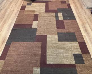 Area rug 5 x 7.5 ft. Multi-color with brown tones.