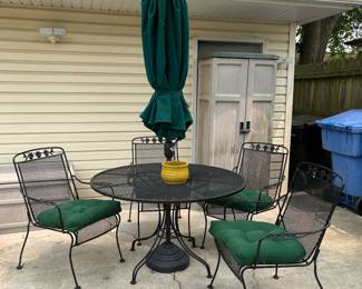 Wrought iron patio table and chairs with umbrella