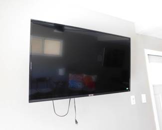 TCL Roku TV, includes wall mount and stand feet
