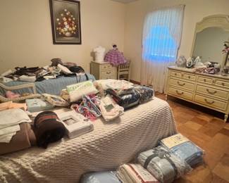 Bedding and twin beds and desk and framed still life