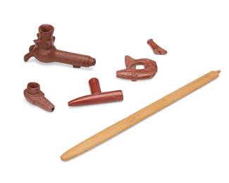 290
A group of Plains carved catlinite pipe ends
Late 19th/mid-20th century
Three with incised detailing, comprising a zoomorphic pipe depicting mountains, birds, and a snake, a fish-form pipe, and two more simplified pipes, together with a carved wood pipe stem
5 pieces
Largest: 4" H x 7.625" W x 2.25" D; Smallest: 1.875" H x 3.625" W x 1.5" D; Stem: 19.25" L
Estimate: $400 - $600