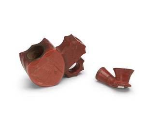 289
Two Native American pipe ends
Late 19th/early 20th century
Comprising one carved catlinite pipe with a chief figure in profile, an American flag, a bow and arrow, a cutlass, and two rifles, and one pottery pipe with incised banded motifs
2 pieces
Catlinite: 2.625" H x 3.875" W x 1.5" D; Pottery: 1.25" H x 2.375" W x 1.375" D
Estimate: $400 - $600