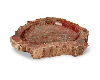 288
A petrified wood bowl
20th century
The carved cross-section of a petrified log with natural edges
3" H x 18.5" W x 12.75" D
Estimate: $300 - $500