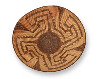 334
A large Pima basket
Early/mid- 20th century, Akimel O'odham; Southwest United States
The large coiled flared bowl with four radiating hooked arms issuing from a black center
5" H x 17.5" Dia.
Estimate: $400 - $600