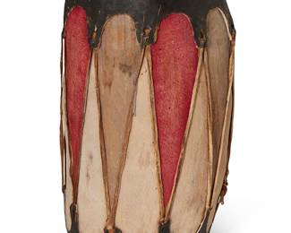205
A Cochiti Pueblo polychrome drum
Early 20th century
The carved and painted wood drum with stretched hide at both ends, painted black and bound by hide strapping
17.5" H x 10" Dia.
Estimate: $400 - $600