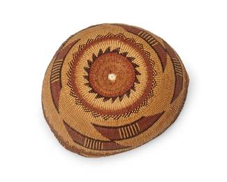 37
A polychrome Hupa/Yurok/Karuk basketry hat
Early 20th century; Northern California
The twined hat with intricate imbricated dark brown and taupe banded stripe and floating geometric motifs
3" H x 7.25" Dia. approximately
Estimate: $400 - $600