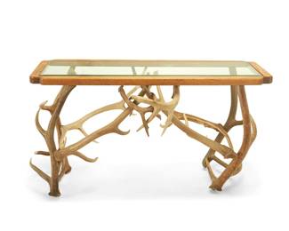 58
A stag antler console table
Late 20th century
The table with deer horn-support construction below a beveled glass top set in a wood frame
31.5" H x 62.5" W x 25" D
Estimate: $500 - $700