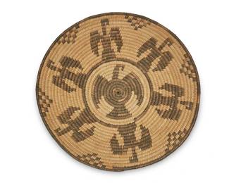 335
A Pima pictorial tray
Early 20th century, Akimel O'odham; Southwest United States
A coiled tray basket with a central eagle motif and an outer band of eagles
2" H x 14" Dia.
Estimate: $300 - $500