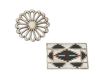 317
Two Southwest sterling silver dress accessories
Mid/late 20th century
Two works:
Charlotte Dishta (b. 20th century, Zuni)
Stamped: C. Dishta / Zuni
A sterling silver buckle with multistone mosaic inlay including mother of pearl, turquoise, and coral, in an overall rug pattern
2" H x 3" W
A Southwest sandcast sterling silver brooch
Unmarked
A round openwork floral concho brooch
2.625" Dia.
2 pieces total
93.3 grams gross
Estimate: $300 - $500