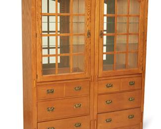 140
A Contemporary Mission-style modular hutch
Early 21st century
One with applied sticker verso: Bassett; each numbered with factory stencil verso
Comprising two wood consoles with brass hardware, each featuring three drawers below a glazed cabinet door opening to reveal two adjustable-height glass shelves and a single display light, electrified
2 pieces
Each: 76.25" H x 30.25" W x 19.25" D
Estimate: $1,000 - $2,000