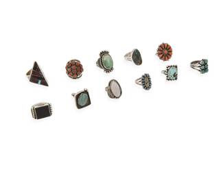 359
A group of Southwest silver and set stone rings
Mid/late 20th century
Three variously marked for maker: D / L. Bennett [for Lee Bennett, Navajo/Diné] / Phyllis [for Phyllis Coonsis, Zuni]; three marked for sterling
Eleven rings featuring various stones including turquoise, coral, sugilite, onyx, and mother of pearl, in various styles including bezel-set, cluster-set, mosaic inlay, shadow box, and silver overlay
11 pieces
Ring sizes: 8.75 to 5.5
91.3 grams gross
Estimate: $200 - $400