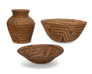 338
A group of Pima baskets
Early 20th century, Akimel O'odham; Southwest United States
Three coiled baskets comprising a tall olla with stepped meandering motifs overall (8" H x 7" Dia.), a large basketry bowl with six-pointed star optical motif (5" H x 11.75" Dia.), and a basketry tray with elaborate interlocking optical motif (2.75" H x 10" Dia.)
3 pieces
Estimate: $400 - $600